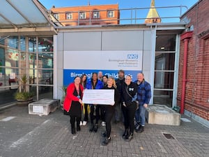 Colleagues at Hyve Solutions presenting their fundraising to Katie Harris, Corporate Fundraising Officer at Birmingham Children's Hospital Charity 