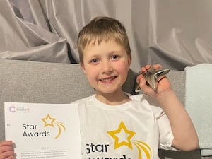 Isaac Perry, six, with his Cancer Research UK Star Award