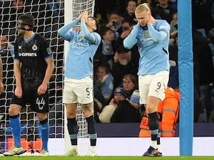 John Stones, left, and Erling Haaland react to a missed chance for Manchester City