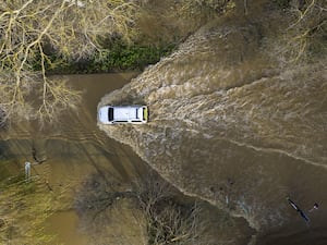 A car drives through floodwater at the Billing Aquadrome in Northamptonshire