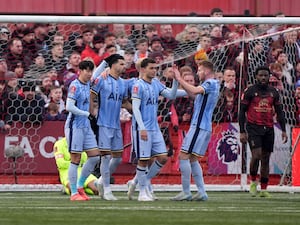 Dejan Kulusevski (second right) and Brennan Johnson (centre) celebrate with team-mates after Tottenham score at Tamworth