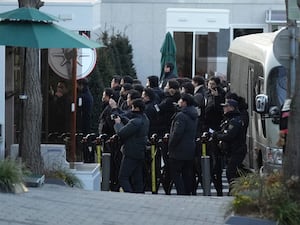 Police officers arrive at the gate of the presidential residence in Seoul