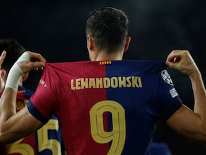 Robert Lewandowski displays the name on the back of his shirt as he celebrates his 100th Champions League goal, for Barcelona against Brest