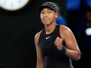 Naomi Osaka reacts after beating Caroline Garcia