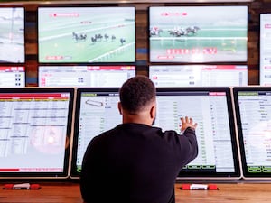 A punter places bets in a Ladbrokes shop