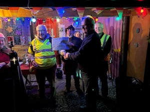 Cheque Presentation by Roger Furniss for the Ludlow Town Tour Guides to Colin Richards, Chair, Ludlow Town Walls Trsuts 