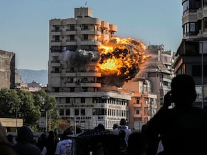 Smoke and flames erupt from a building hit in an Israeli air strike in Chiyah,