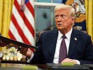 US President Donald Trump signs executive orders in the Oval Office of the White House