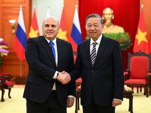 Russian Prime Minister Mikhail Mishustin and Vietnamese Communist Party chief To Lam shake hands in Hanoi