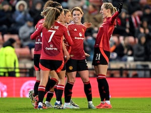 Manchester United’s Rachel Williams celebrates with teammates after scoring her sides third goal during the Adobe Women’s FA Cup fourth round match at Leigh Sports Village.