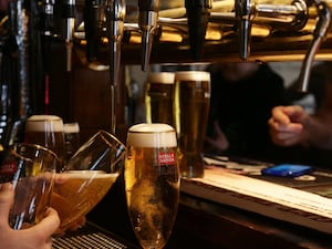 Drinks being poured in a pub