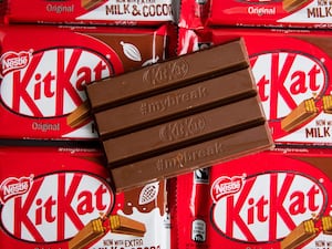 KitKat chocolate bar on top of KitKat packets