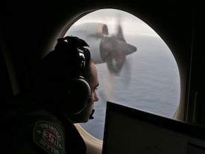 Flight officer Rayan Gharazeddine scans the water in the southern Indian Ocean off Australia from a Royal Australian Air Force AP-3C Orion during a search for the missing Malaysia Airlines Flight MH370