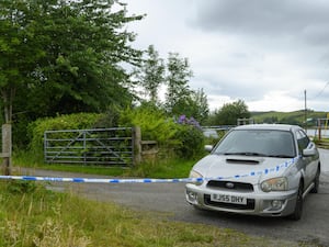 Police tape marking a cordon in a rural area