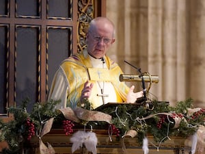 A man in archbishop's robes in a pulpit