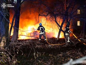 Firefighters extinguish a fire following a Russian rocket attack that hit a multistorey apartment building in Sumy, Ukraine