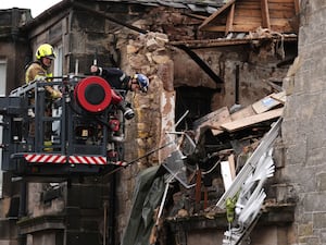 Fire investigators examine a blast site in Scotland