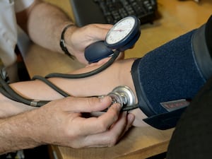 GP takes a patient's blood pressure