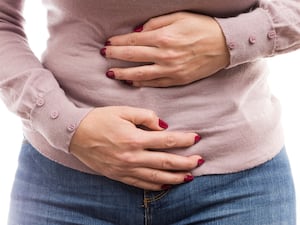 Woman holding her tummy in pain