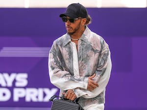 Mercedes driver Lewis Hamilton walks through paddock as he arrives at the Lusail International Circuit Qatar