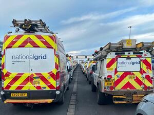 National Grid vans wait in a queue