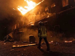 Firefighters extinguish a fire after a Russian attack on a civil factory in Kharkiv