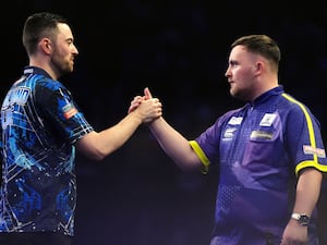 Luke Humphries, left, and Luke Littler shake hands on stage