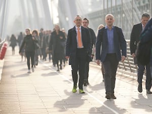 Commuters walking across a bridge