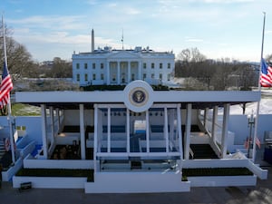 Workers continue with the finishing touches on the presidential reviewing stand