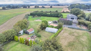 Hollies boasts approximately eight acres of land with an equestrian building, a Dutch barn and static caravan. Picture: Rightmove and Roger Parry & Partners.