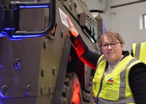 Minister for Defence Procurement and Industry Maria Eagle applies a Made in Britain sticker to a Boxer vehicle during a visit to RBSL Telford.