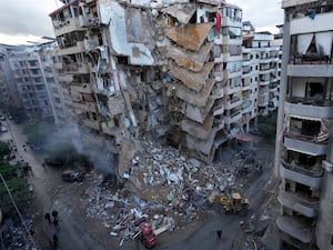 Bulldozers remove the rubble of a destroyed building that was hit Sunday night in an Israeli airstrike in Dahiyeh, in the southern suburb of Beirut, Lebanon