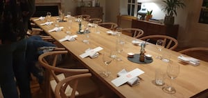 The table is elegantly set up and allows people to come together and enjoy a drink and meal as a group