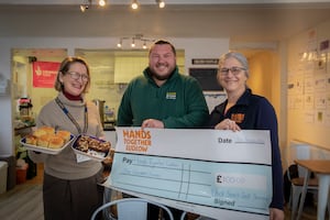 Richard Warner, Lock Stock regional manager for North East and Mid Wales hands over a cheque to Julie Doig, Food Coordinator and Susie O'Hagan, Operations Manager  at Hands together Ludlow.                     Picture Mandy Jones