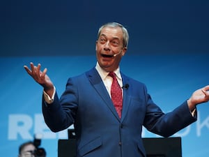 Reform UK leader Nigel Farage speaking on stage