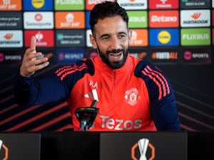 Ruben Amorim raises his hands to gesture to the media during a press conference