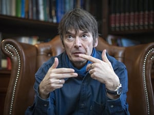 Sir Ian Rankin gesturing with his hands while speaking