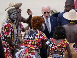 President Joe Biden watches a traditional dance after arriving at Catumbela airport in Angola