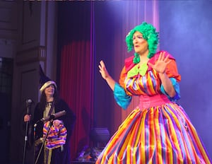 Gareth Jones as Dame Gertie Godiva watched by Merlin played by Jane Blees. 