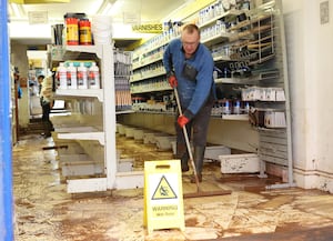 Steve cleaning up inside A.H. Caldicott & Sons LTD after the flooding in Tenbury Wells. Photo: Anita Maric/SWNS