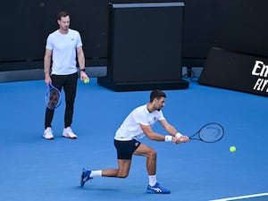 Novak Djokovic (right) plays a backhand as coach Andy Murray watches during a training session ahead of the Australian Open at Melbourne Park