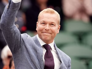 Sir Chris Hoy waves to the crowd from the Wimbledon Royal Box