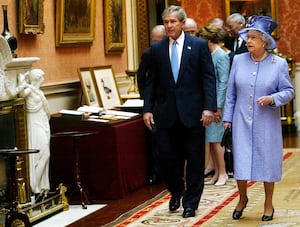 Queen Elizabeth II accompanies America's President George Bush as they enter the Queen's Gallery at Buckingham Palace at the start of the President's state visit to Britain