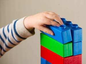 A child plays with coloured building blocks