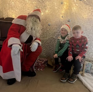 Eban and Grae Vaughan with Santa in his grotto in Knighton.