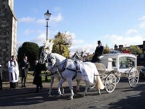 A horse-drawn carriage carrying the coffin of Liam Payne arrives for the funeral service