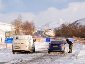 Snow gates closed on snowy-covered road