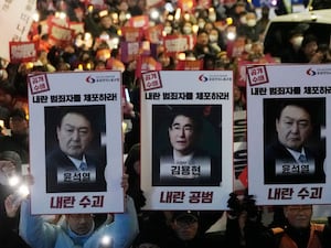 Protesters with images of South Korean President Yoon Suk Yeol and former South Korea Defence Minister Kim Yong Hyun, centre,