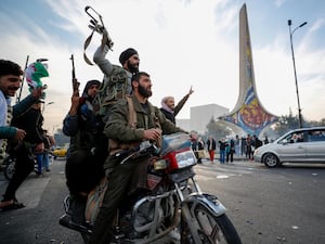 Syrian opposition fighters celebrate the fall of the Syrian government in Damascus