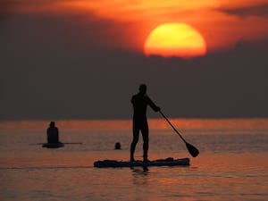 Paddleboarders on the North Sea at Cullercoats Bay in North Tyneside